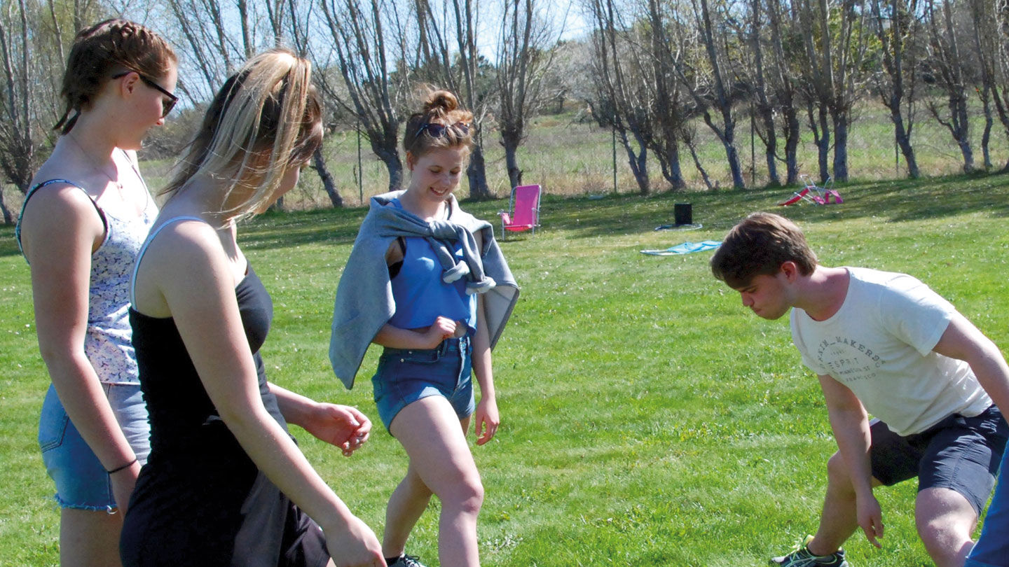 Ungdomar strechar utomhus.